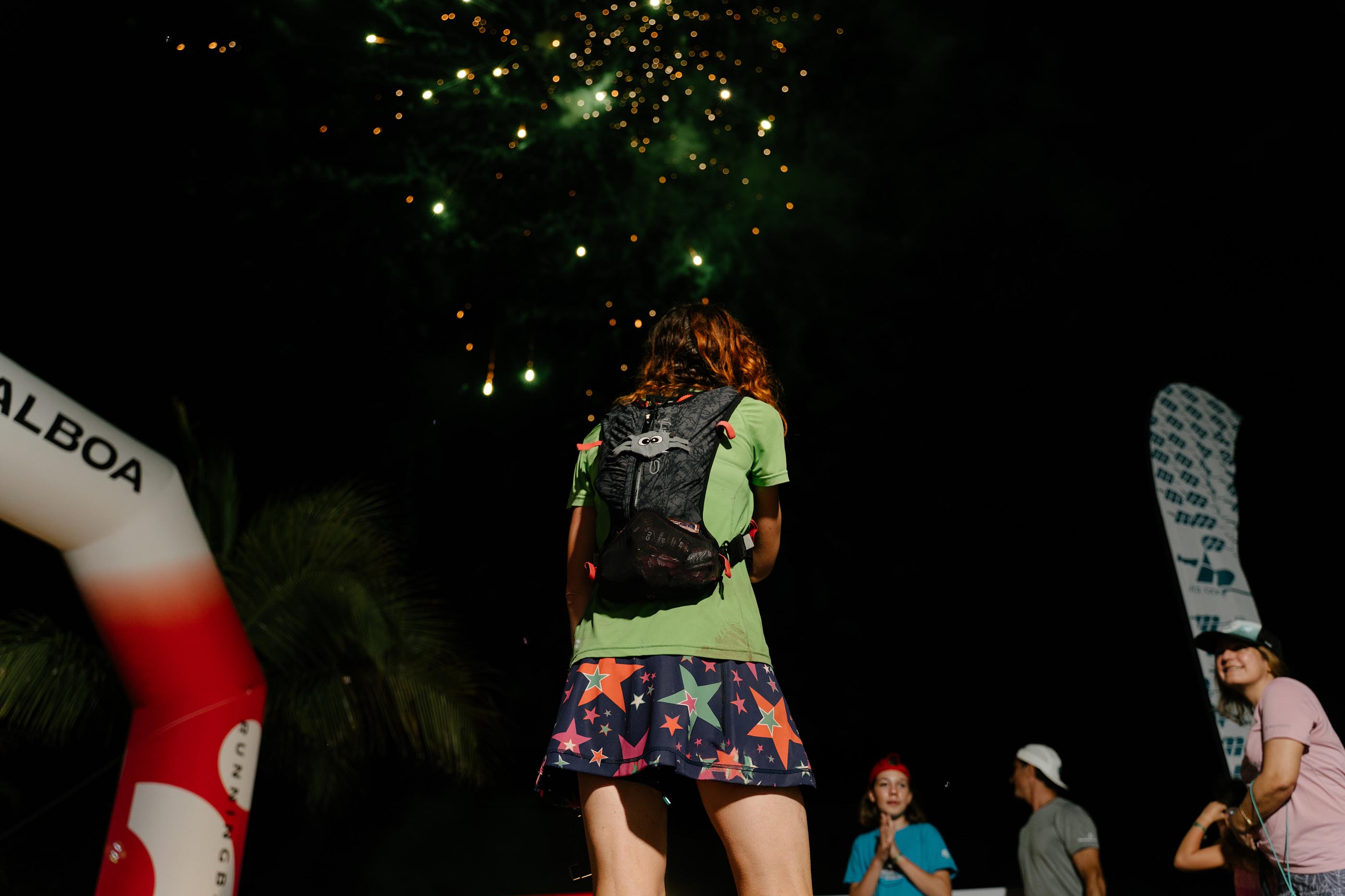 Runner finishing at night under fireworks at El Reto del Indio